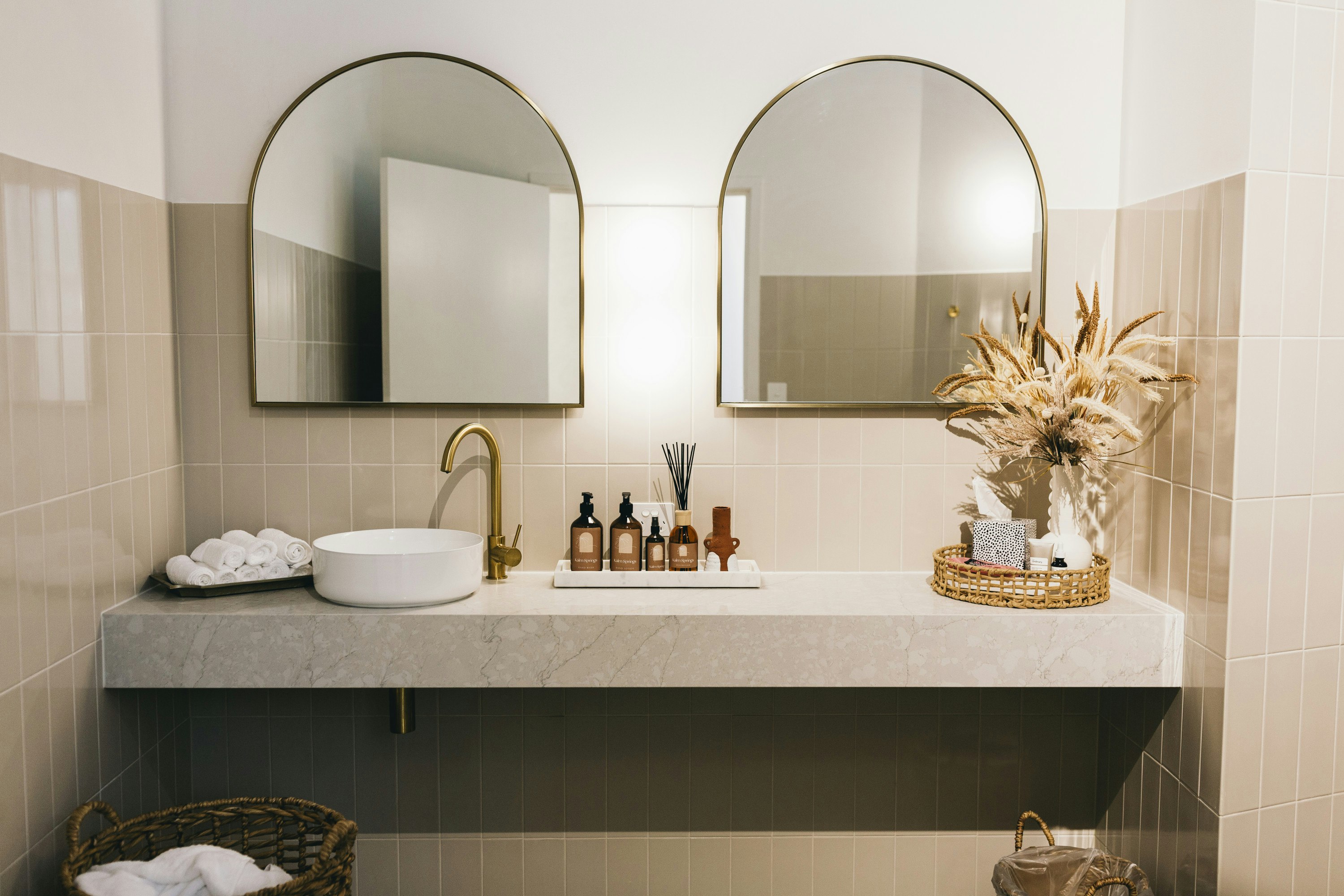 a sink with two mirrors